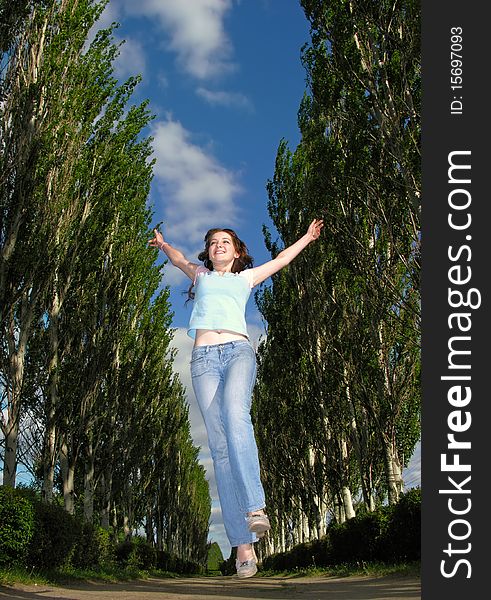 cheerful girl running in alley. cheerful girl running in alley