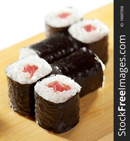 Maguro Maki Sushi - Roll with Fresh Tuna. Served on the Wooden Plate. Maguro Maki Sushi - Roll with Fresh Tuna. Served on the Wooden Plate
