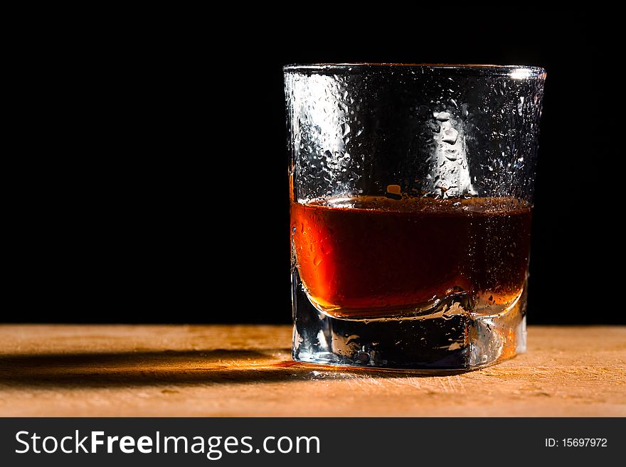 Glass from whisky on a wooden table