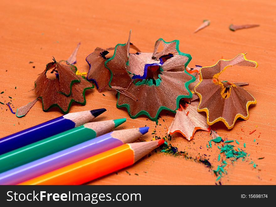 Pencils with a sharpener and shaving on a table