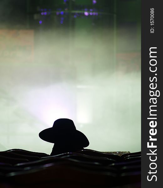 Silhouette of the performer waiting for his turn on the stage
