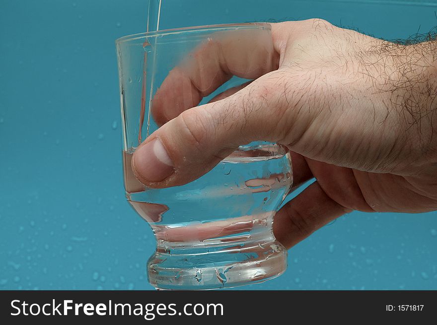 Hand keeping glass with water. Hand keeping glass with water