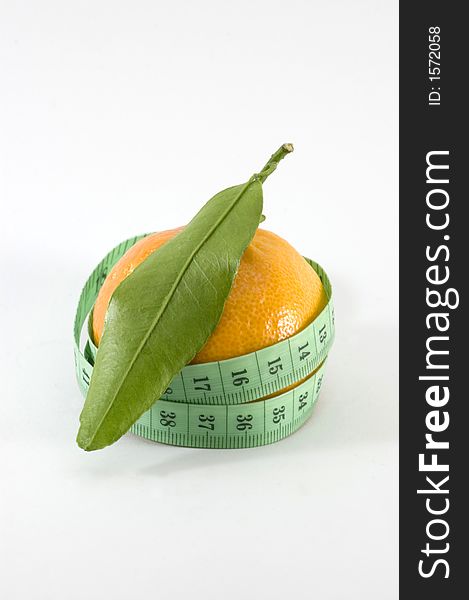 Small orange surounded by a 	
metric ribbon in white background. Small orange surounded by a 	
metric ribbon in white background