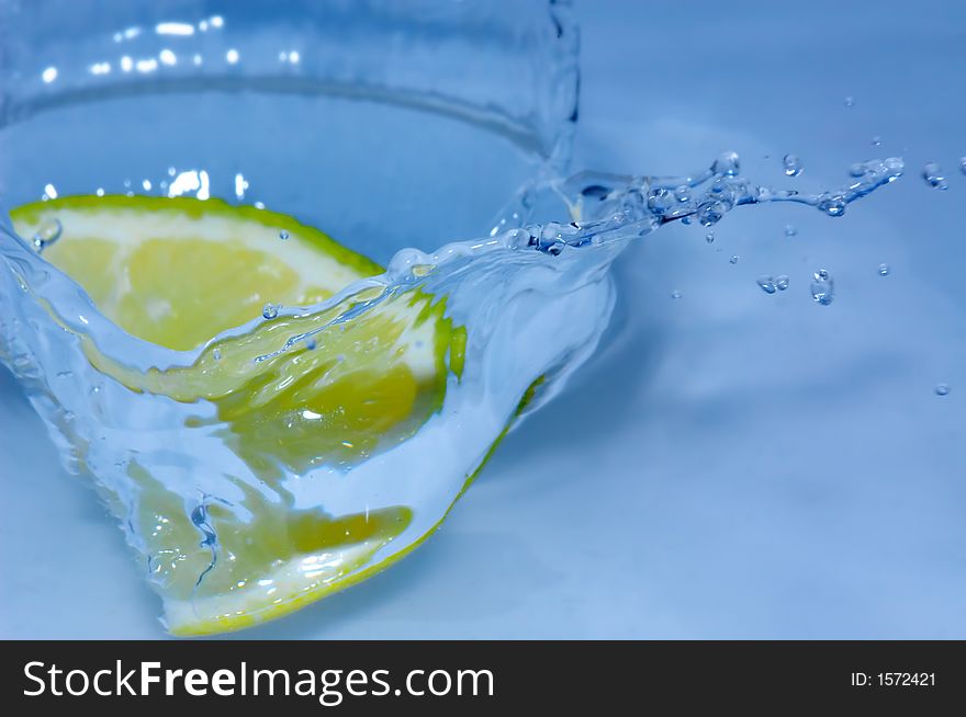 Lemon splashing into fresh water