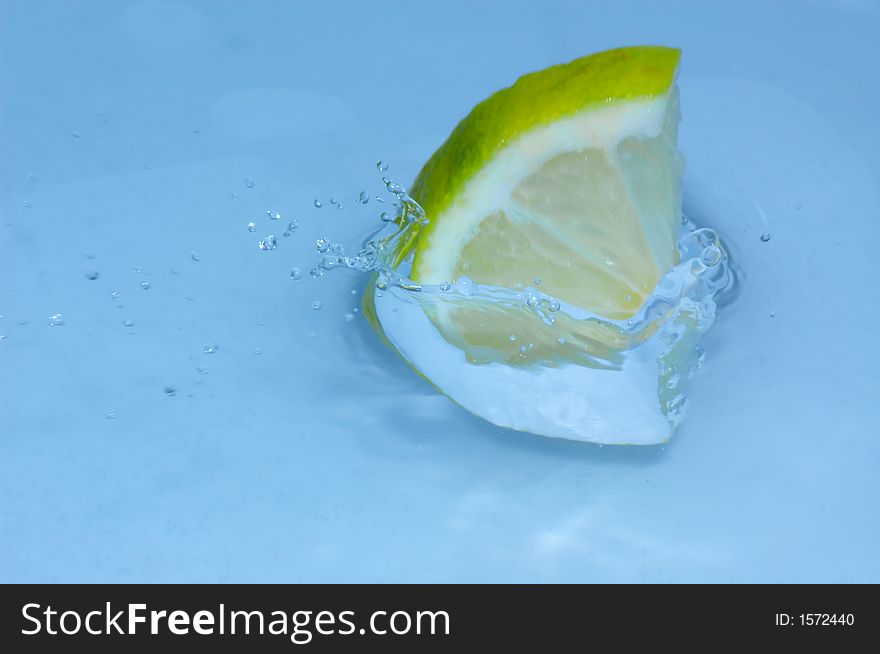 Lemon splashing into fresh water