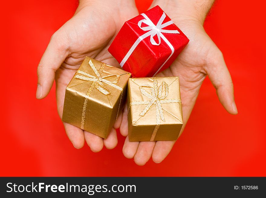 Hands giving presents in a red background