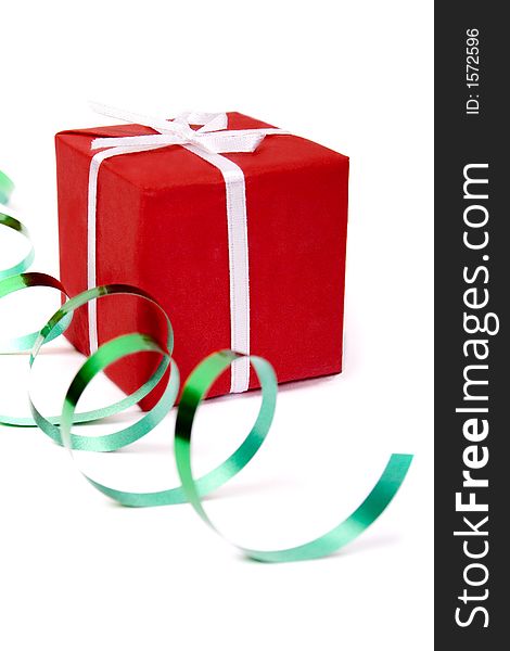 Red gift and green ribbon over white background. Red gift and green ribbon over white background