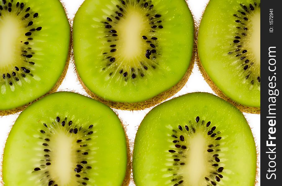 Kiwi fruit slices aligned on white background. Kiwi fruit slices aligned on white background