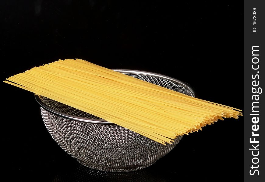 Close up of spaghetti over a colander