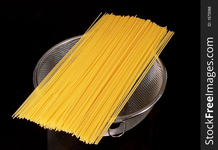 Close up of spaghetti over a colander