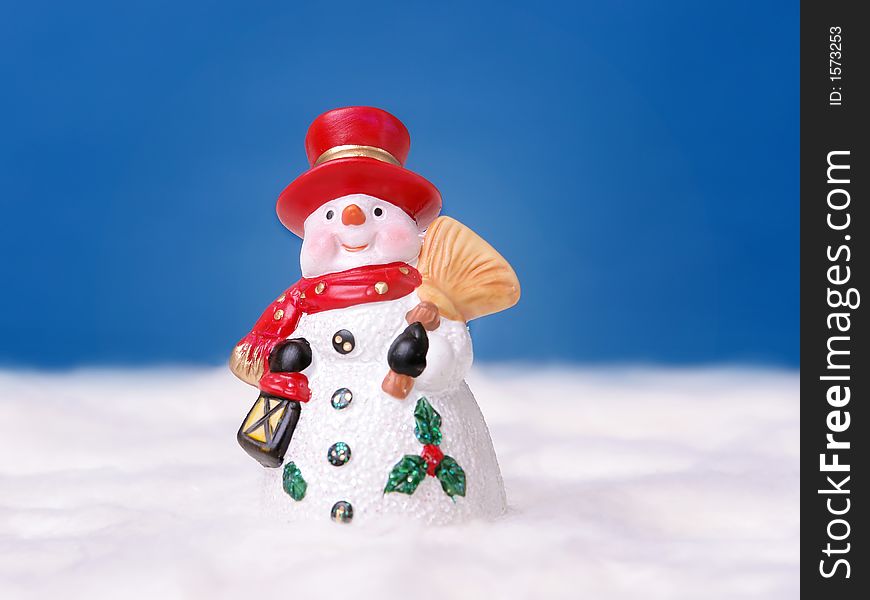 Snowman with red hat over deep blue sky. Snowman with red hat over deep blue sky