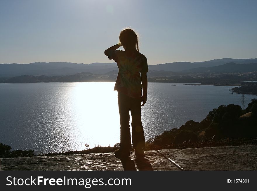 A girl looks out at the sunset. A girl looks out at the sunset