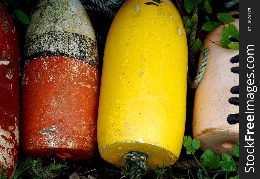 Multi COlored Foam fishing buoys sitting in grass