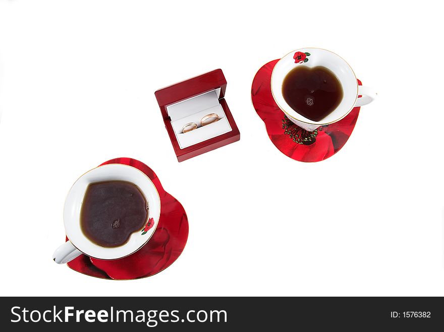 Heart-shaped cups and wedding rings