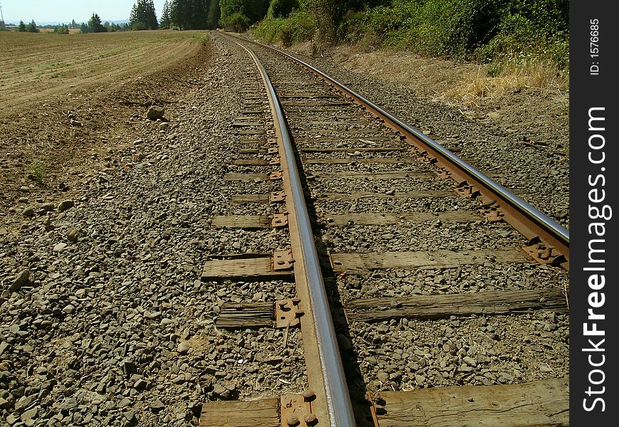 Railroad tracks on rocks trailing off into the distance. Railroad tracks on rocks trailing off into the distance