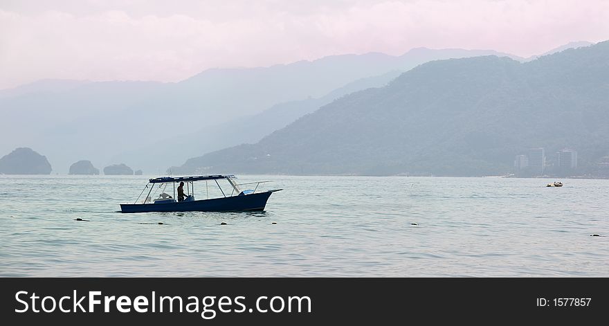 Fisherman on his boat in the bay at sunrise. Fisherman on his boat in the bay at sunrise