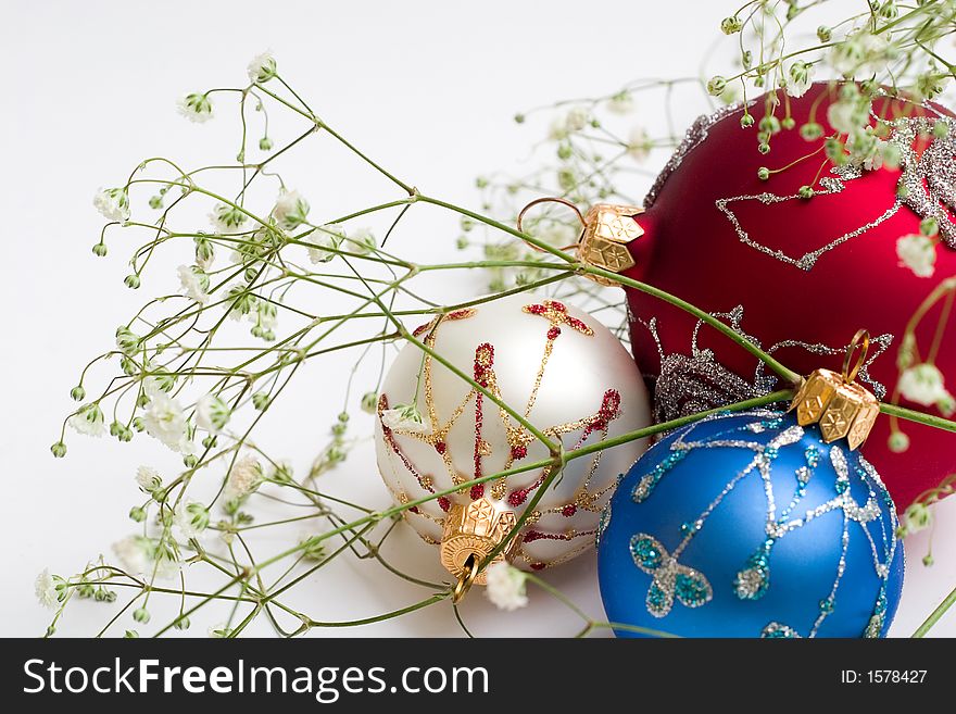 Three christmas balls with green branch. Isolated, white background