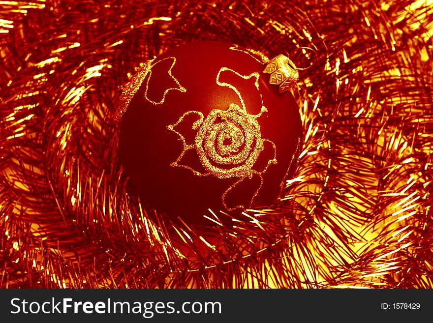 Red christmas ball and shiny spangle, soft-focues closeup. Red christmas ball and shiny spangle, soft-focues closeup
