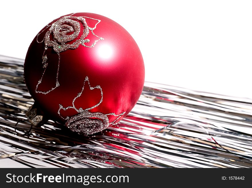 Red christmas ball and white shiny spangle. Isolated on white background. Red christmas ball and white shiny spangle. Isolated on white background