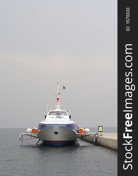 Greek hydrofoil passenger ferry tied to harbour wall. Greek hydrofoil passenger ferry tied to harbour wall