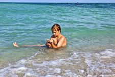 Boy Enjoys The Clear Water In The Ocean Stock Images