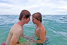 Boys Having Fun In The Clear Sea Stock Photo