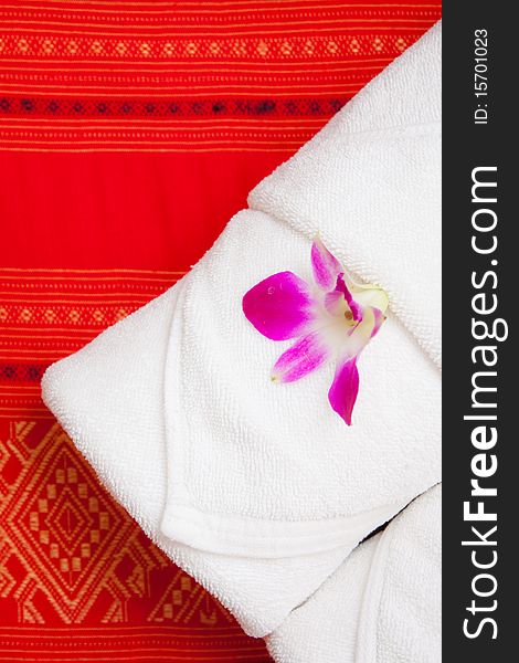 Ochid on white towel in Thai style hotle. Ochid on white towel in Thai style hotle