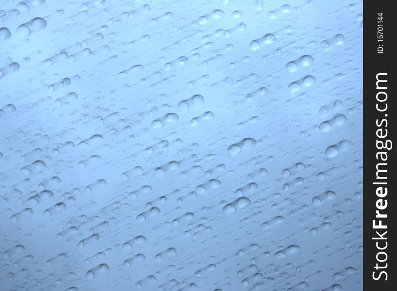 Blurred Raindrops on a Blue Background. Blurred Raindrops on a Blue Background