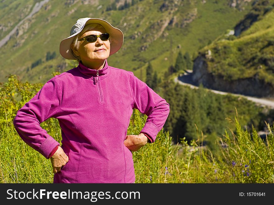 Old woman with mountains flowers. Old woman with mountains flowers