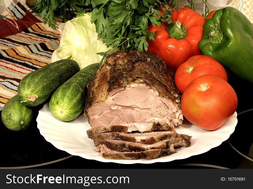 Fresh baked meat on the plate with ripe vegetables