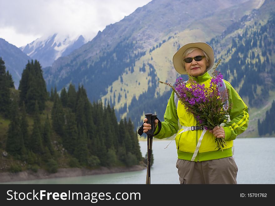 Old woman with mountains flowers. Old woman with mountains flowers