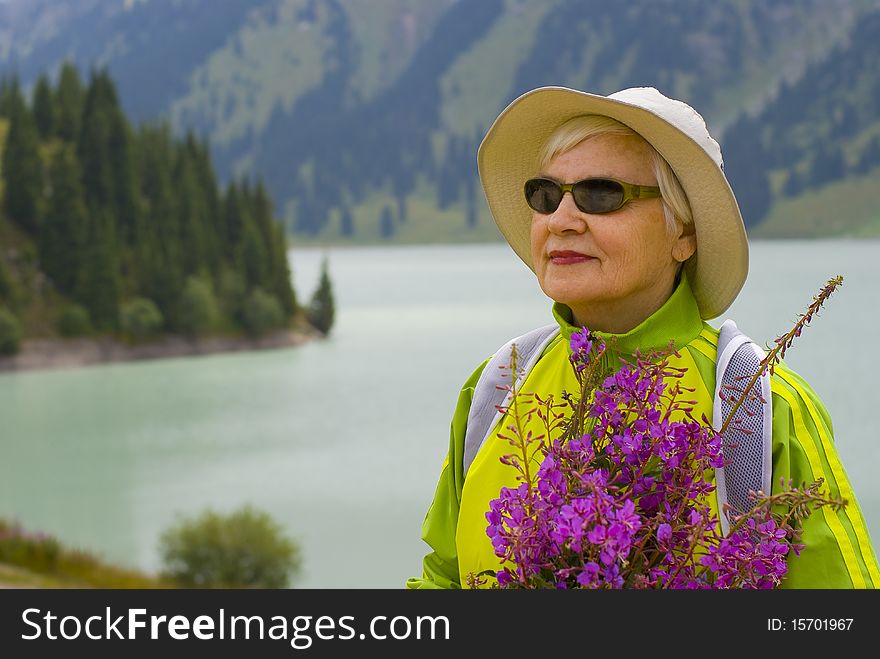 Old woman with mountains flowers. Old woman with mountains flowers
