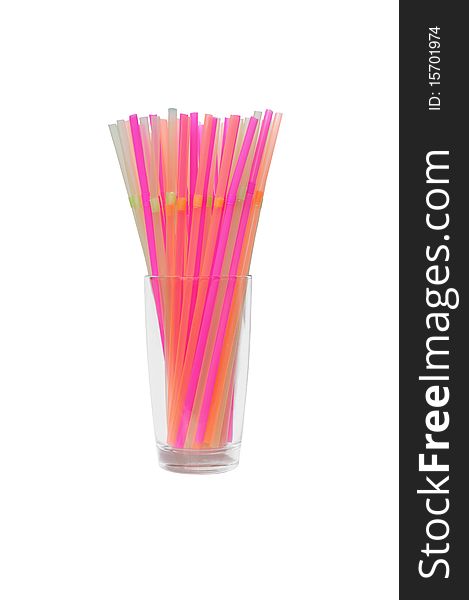 Isolated glass with many bright drinking straws in it. Isolated glass with many bright drinking straws in it