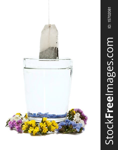 Preparing tea in glass cup with flowers. Isolated on white background