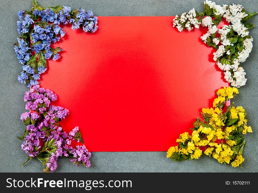 Red paper blank on grey background with flowers design