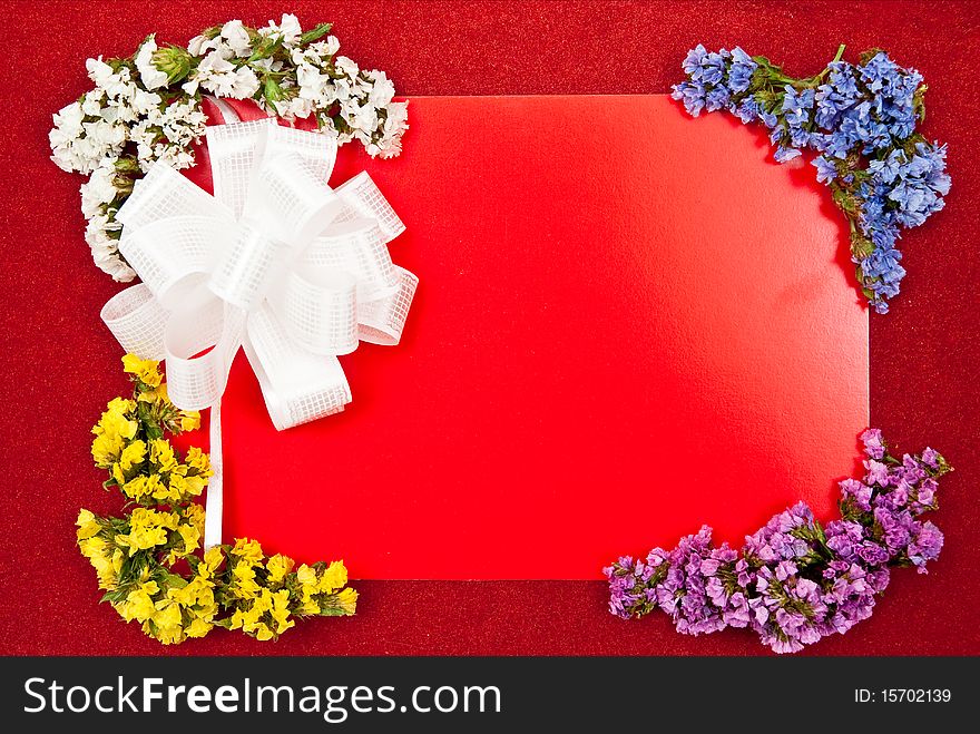 Greeting card with white bow and flowers on red. Greeting card with white bow and flowers on red