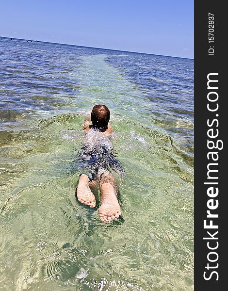 Boy enjoys the wonderful clear ocean. Boy enjoys the wonderful clear ocean