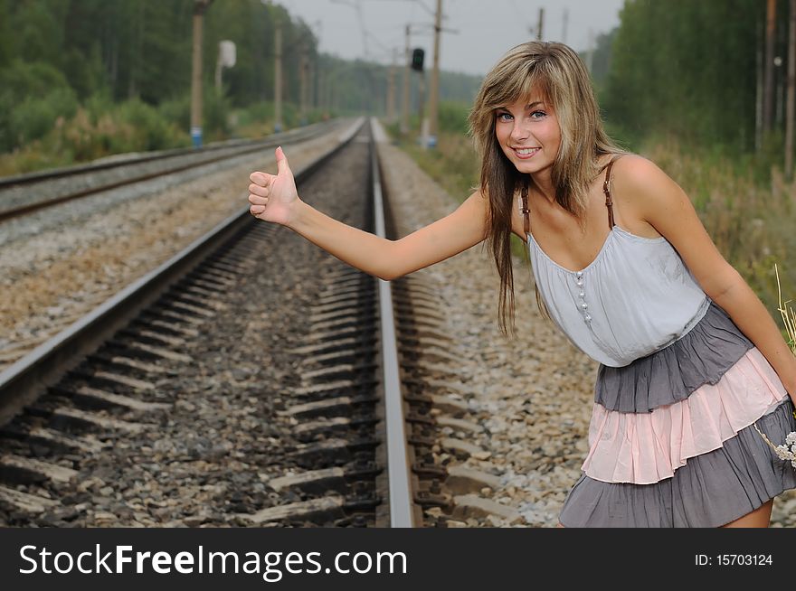 The young beautiful girl at a station