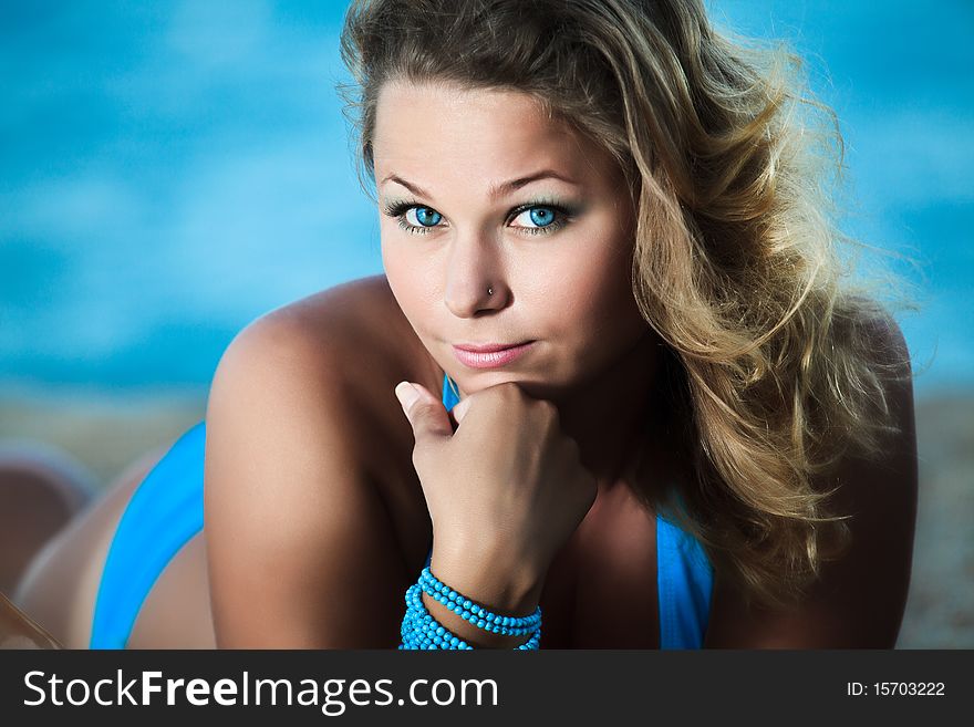 Young beautiful woman sunbathing on the sand