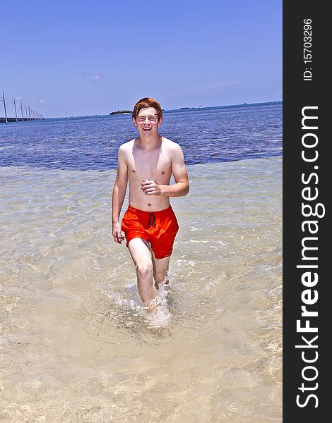 Boy runs along the beach of the wonderful clear ocean. Boy runs along the beach of the wonderful clear ocean