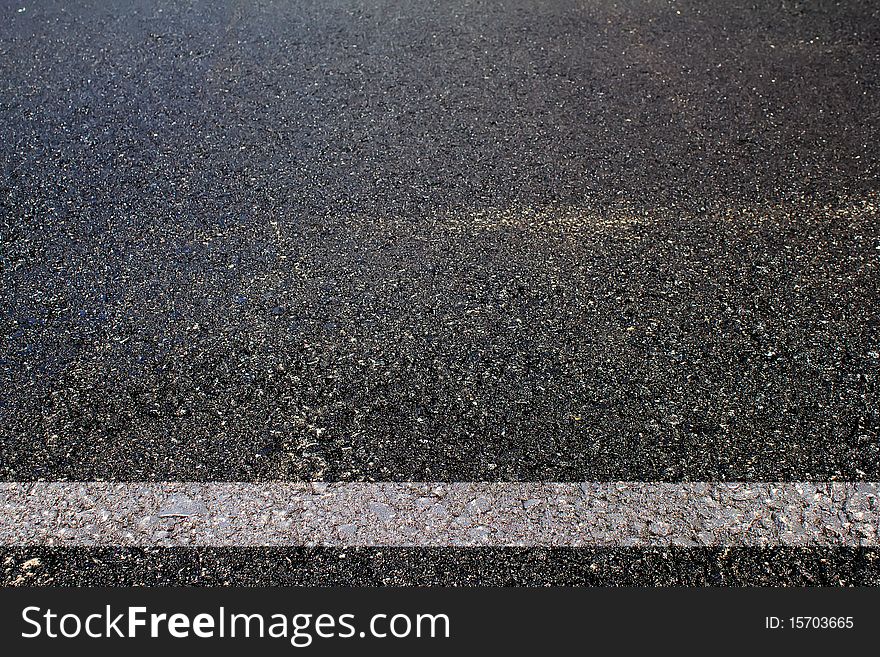 Road asphalted with a white dividing strip abstract background. Road asphalted with a white dividing strip abstract background
