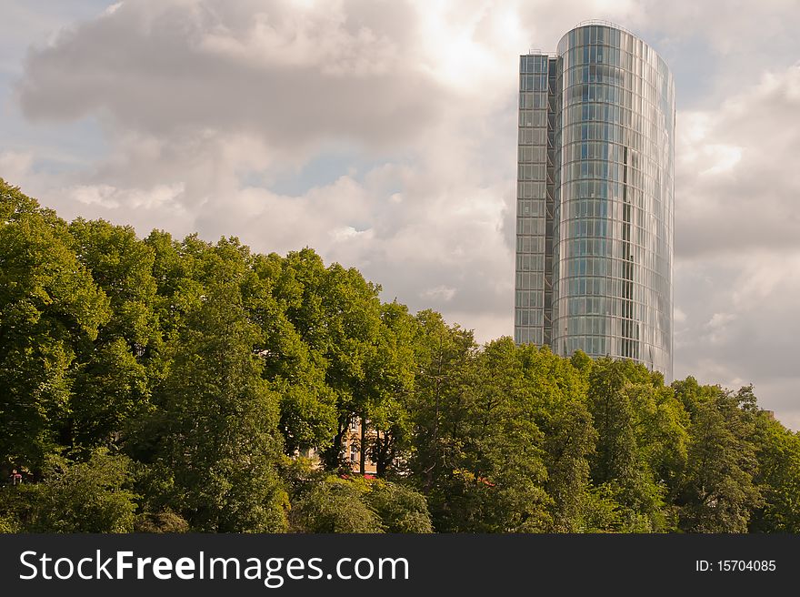 A corporate building with a park (the Swan park in Düsseldorf) in front of it.