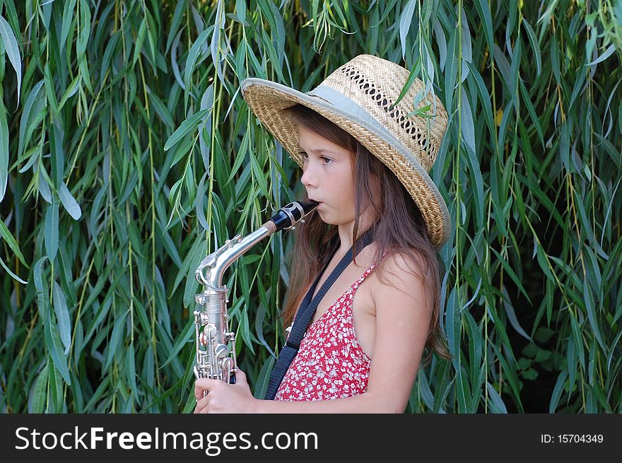 Girl with saxophone outdoor.Near Kiev,Ukraine