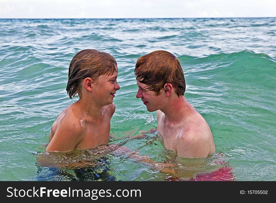 Boys having fun in the beautiful clear sea. Boys having fun in the beautiful clear sea