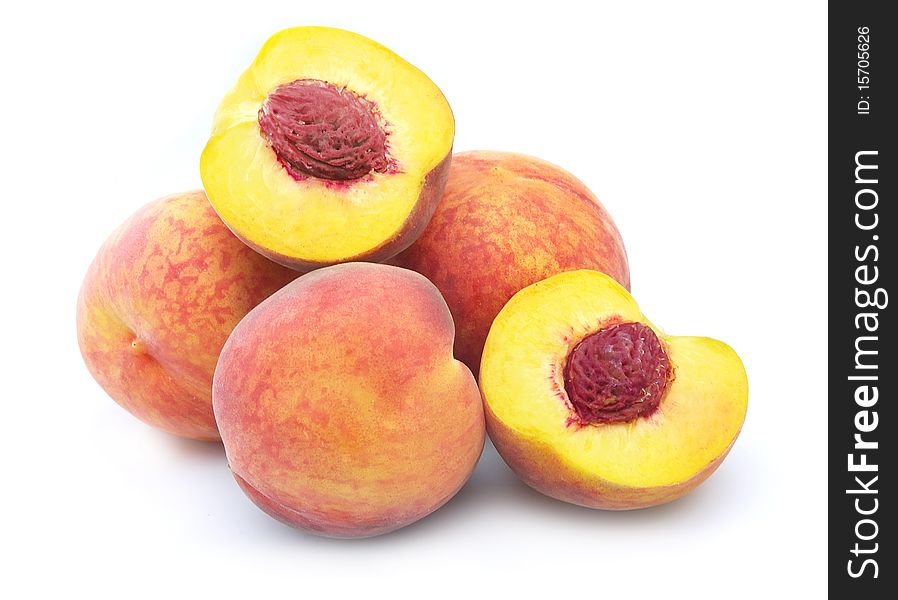 Ripe peaches whole and segments a white background