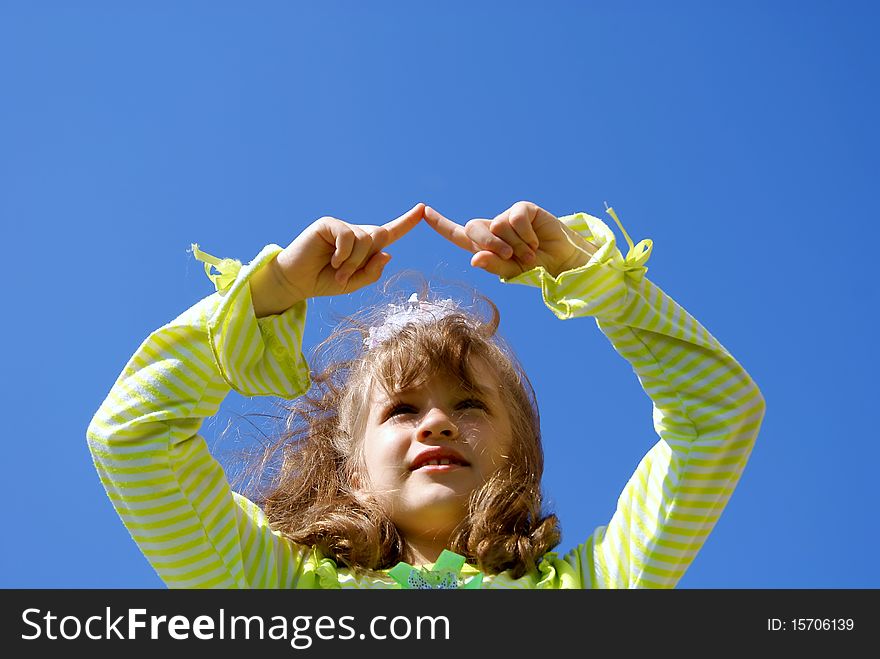 The girl draws in the dark blue sky fingers having lifted upwards hands. The girl draws in the dark blue sky fingers having lifted upwards hands