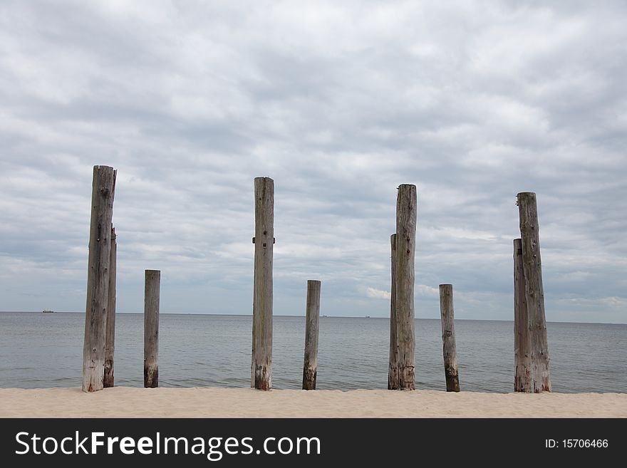 Rows of piles on the sea beach - outdoor