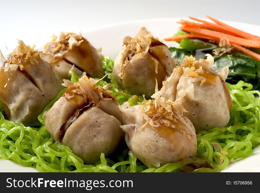 Noodle with pork meat ball on white plate