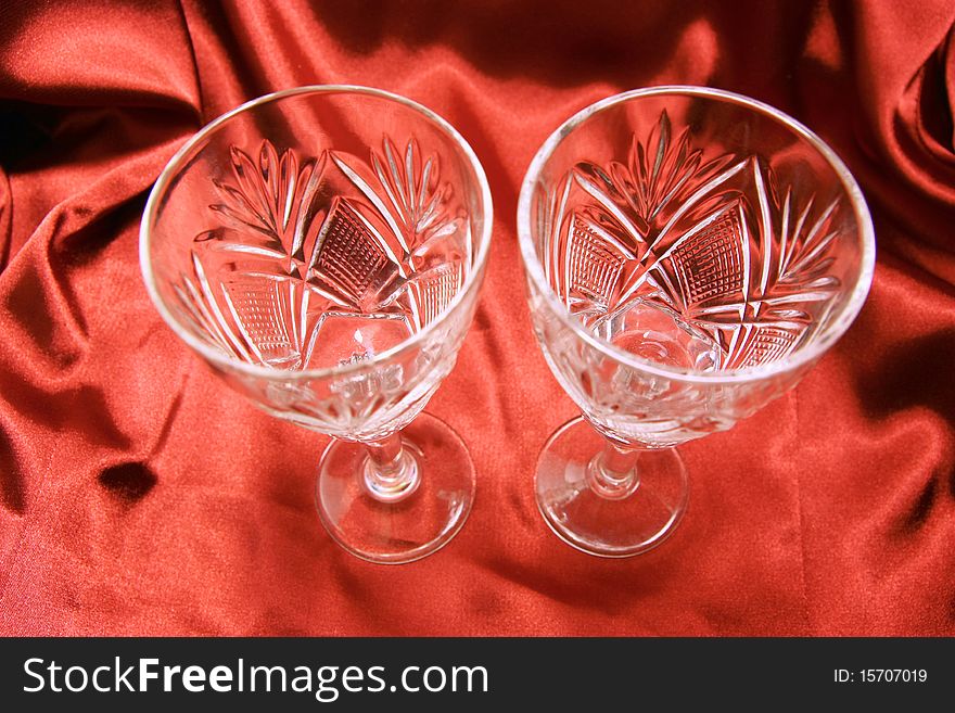 Two glasses on the red cloth background