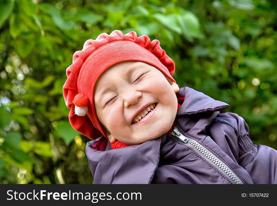 Portrait of laughing little girl in the park